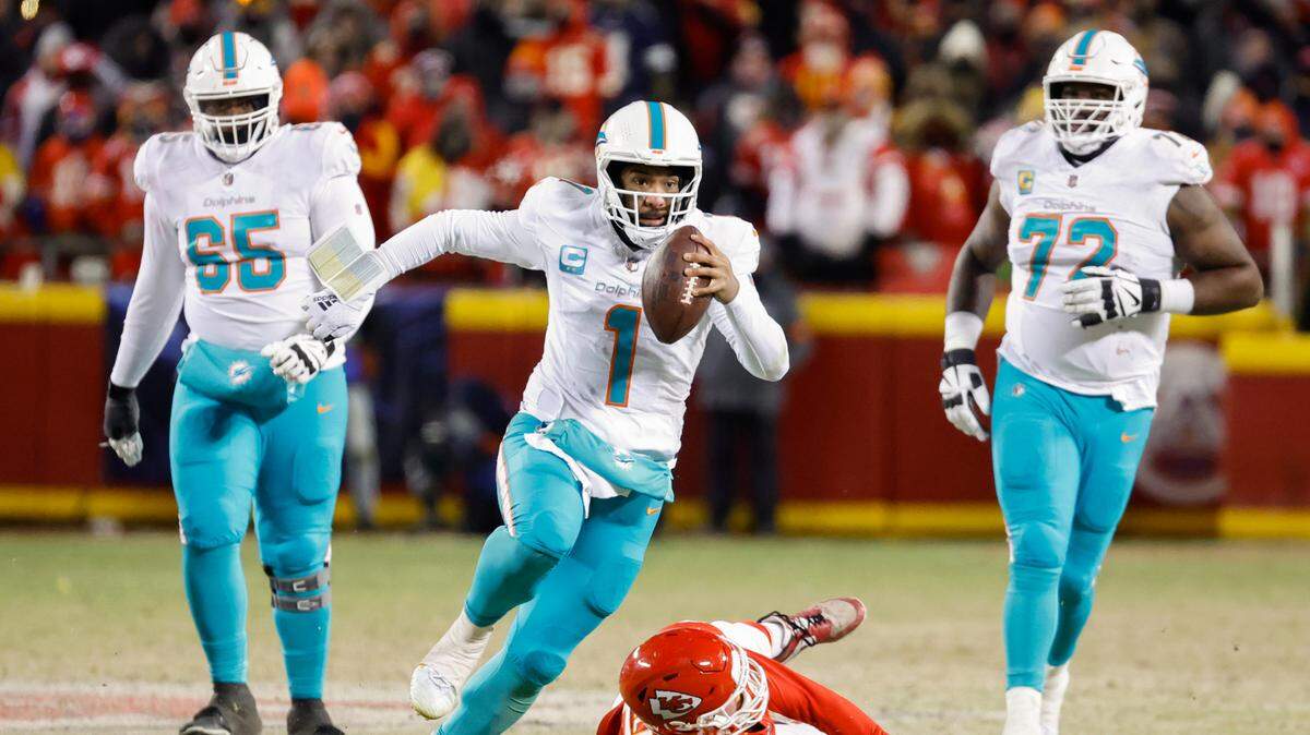 Miami Dolphins quarterback Tua Tagovailoa (1) scrambles in the second half against the Kansas City Chiefs at GEHA Field at Arrowhead Stadium in Kansas City, Missouri, on Saturday, January 13, 2024.