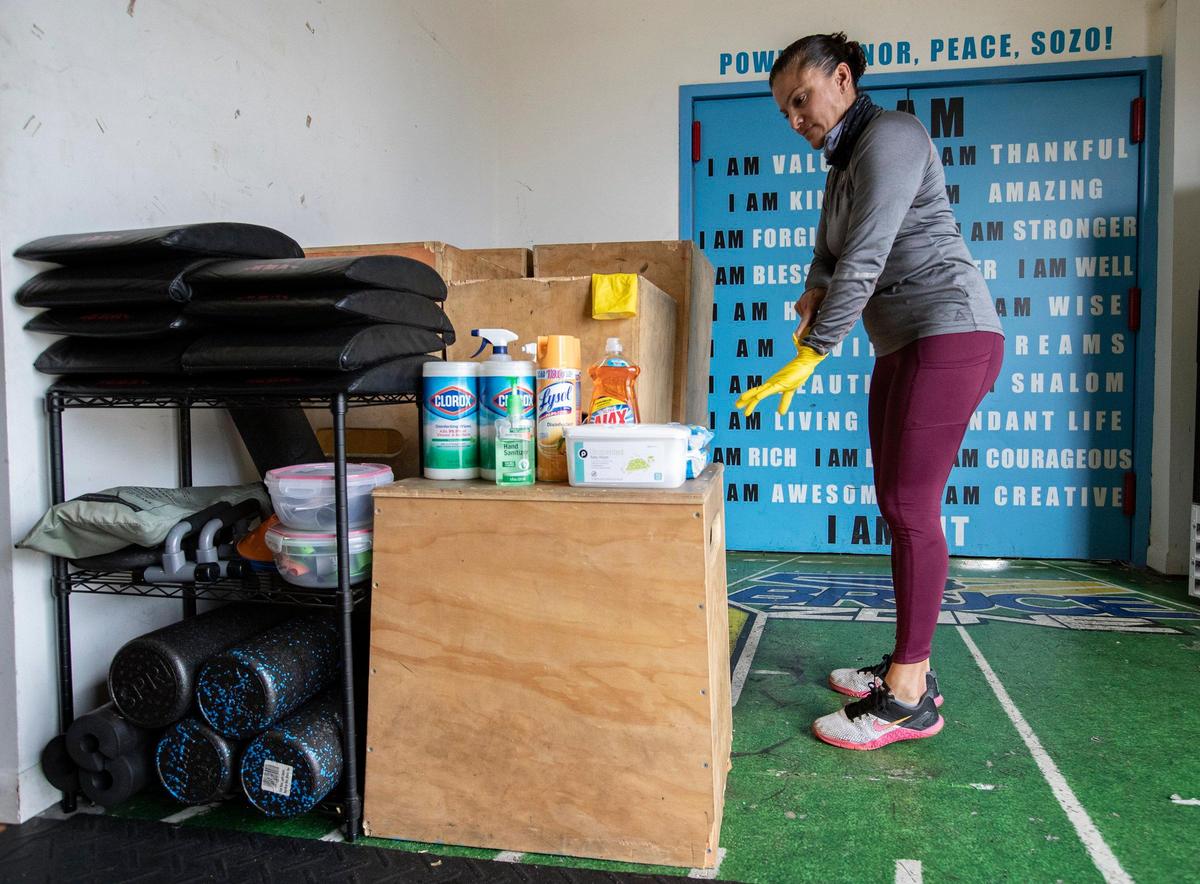 Head coach Milena Maestre prepares to sanitize surfaces at CrossFit Increase at Bruce Zone in Fort Lauderdale on Wednesday, May 20, 2020.