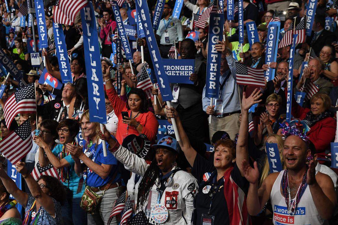 Delegates celebrate as Democratic Presidential Nominee Hillary Clinton addresses the Democratic National Convention in Philadelphia on July 28, 2016.