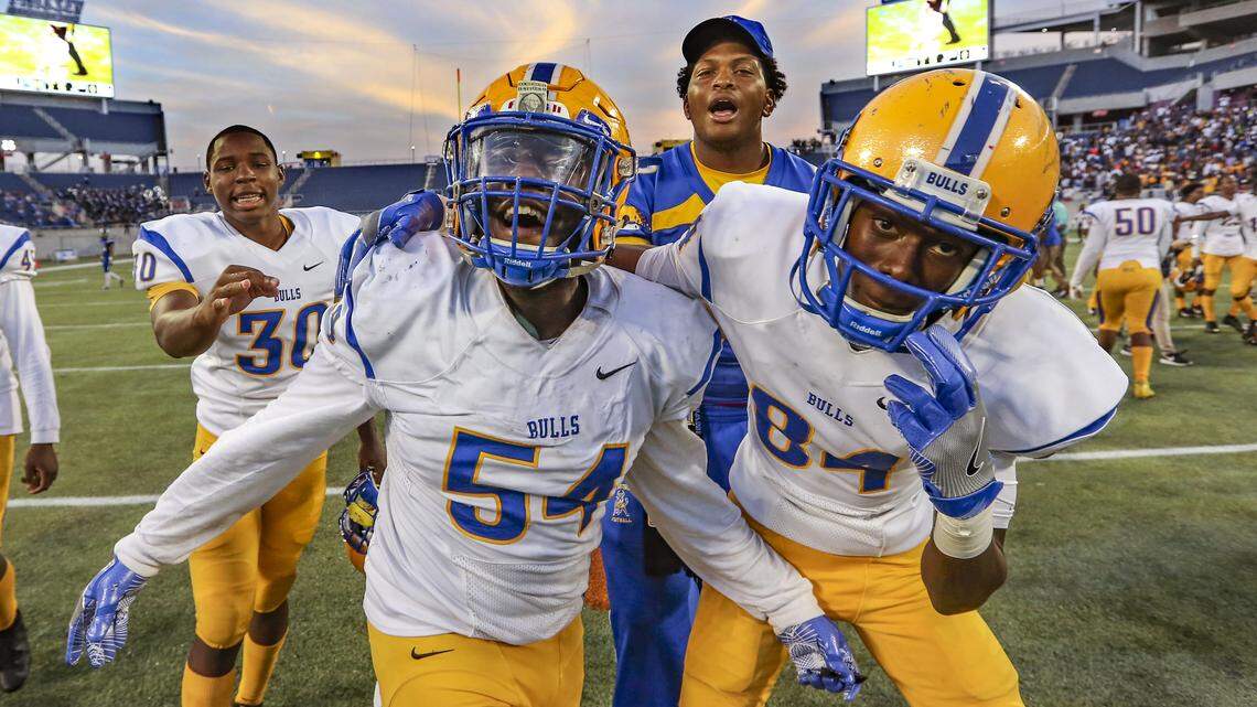 The Bulls’ Marty Moore (54) and Victor Thompson (84) celebrate after Miami Northwestern defeats Armwood Hawks during the Florida High School Athletic Association State Championship Class 6A Saturday, Dec. 8, 2018, at Camping World Stadium in Orlando.