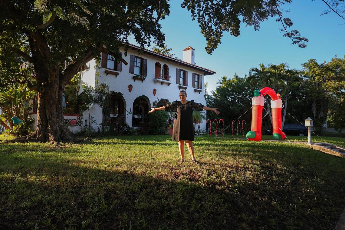 Susana Baker poses in front of her house in Buena Vista. Baker says she fell in love with the house the moment she saw it from this angle, perched on a slight hill.