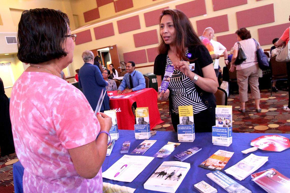 Kim Maxson receives information on Medicare from Leslie Quintanilla-Lopez, SHINE, Serving Health Insurance Needs of Elders, volunteer counselor, at a senior health fair at the William F. Dickinson Community Center in Homestead, on Monday, September 28, 2015.