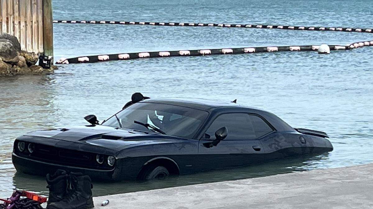 Key West fire fighters remove a Dodge Challenger a man drove into the ocean Sunday, April 28, 2024.