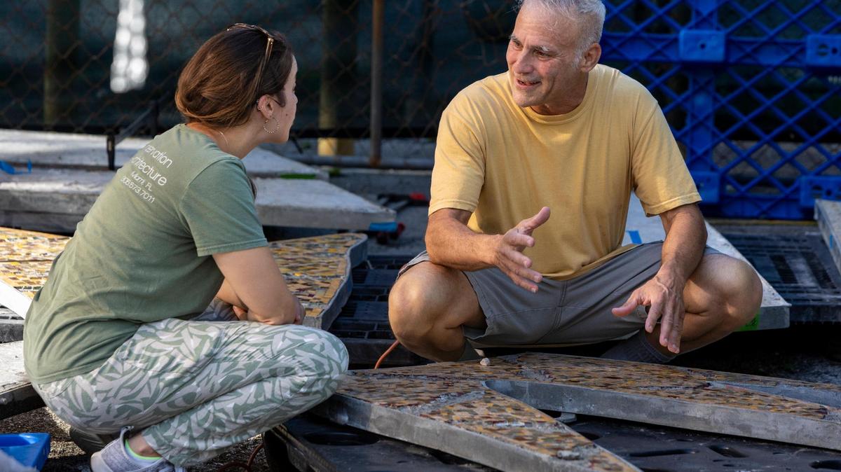 Art conservator Elena Bowen, left, talks to Miami Beach preservationist/hotel operator Mitch Novick as they view sections of a monumental 1950s mosaic mural depicting the Greek god Apollo that is undergoing restoration by RLA Conservation at Wynwood’s Bakehouse Art Complex. Novick saved the 1950s mural from destruction in 2015.