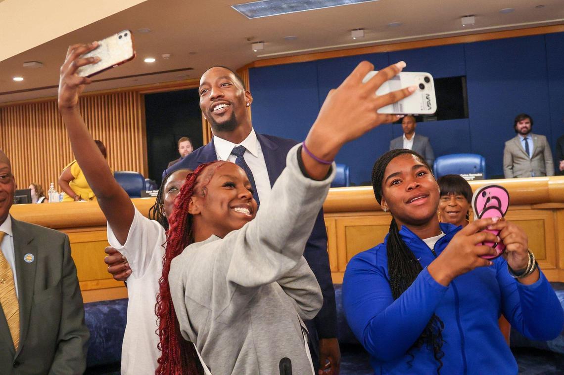 Bam Adebayo, who won a gold medal in men’s basketball, left, is surrounded by Miami Northwestern students as they quickly make a quick selfie with the Olympian as six outstanding Olympians from Miami-Dade were honored with keys to the County, recognizing their remarkable achievements and contributions to sports on Wednesday, September 4, 2024, inside Miami-Dade Commission chamber at the Stephen P. Clark Center in Miami, Florida.