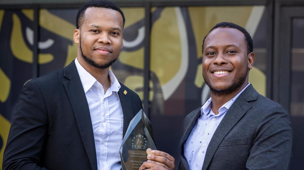 Mac Alabre, left, CEO of Lien Library. and Rohansen Joseph, chief operating officer, hold the first place trophy their startup firm won March 24, 2023 at the Miami Herald’s annual Startup Pitch Competition.