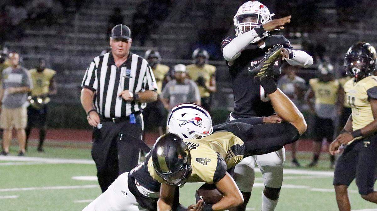 Chaminade-Madonna Lions defenders bring down Treasure Coast Titans George Roberts (4) during the football game on Thursday, November 3, 2022 at Chaminade-Madonna HS. Andrew Uloza / for Miami Herald