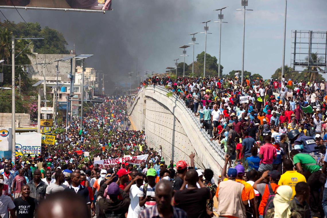 Thousands of demonstrators march in the street of Port-au-Prince on Thursday, Feb. 7, 2019, as they chant anti-government slogans during a protest to demand the resignation of President Jovenel Moise and an account of how funds from Venezuela’s PetroCaribe oil fund have been used by the current and past administrations.
