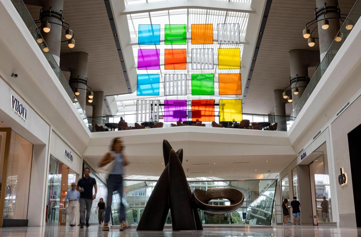Wendell Castle’s bronze sculpture, ‘Veiled in a Dream’ (bottom), and Daniel Buren’s immersive artwork featuring 16 plexiglass panels, ‘The Colored Screens’ (above), are among the many art installations available for visitors to see at Aventura Mall. This photo is from Sept. 25, 2024.