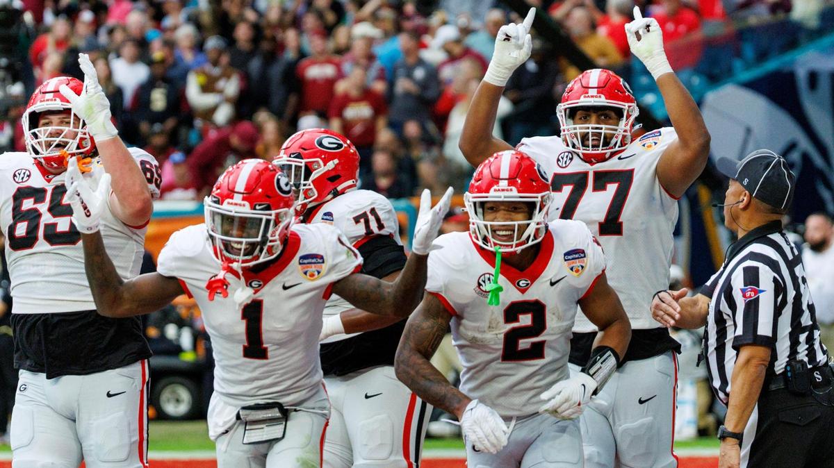 Georgia Bulldogs running back Kendall Milton (2) celebrates with teammates after scoring a touchdown against the Florida State Seminoles during the second half of the 90th annual Capital One Orange Bowl at Hard Rock Stadium on Saturday, Dec. 30, 2023 in Miami Gardens, Fla.