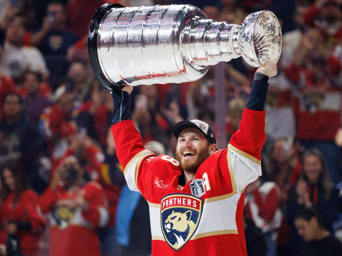 Florida Panthers left wing Matthew Tkachuk (19) lifts the Stably Cup after the Florida Panthers defeated the Edmonton Oilers in Game 6 winning the NHL Stanley Cup Final at Amerant Bank Arena