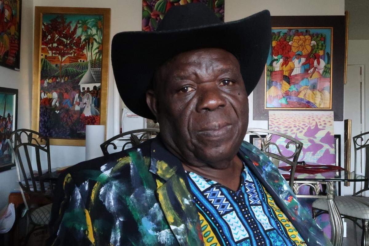 Louis Rosemond lived in the Little Haiti neighborhood of Miami, Florida, for 30 years, but was evicted in 2016 when his landlord sold the apartment building to developers who are preparing to build high-rise, high-priced condominiums on the property. Rosemond, pictured in his new apartment in Opa Locka, Florida, on April 19, 2022, says developers are destroying his old neighborhood.