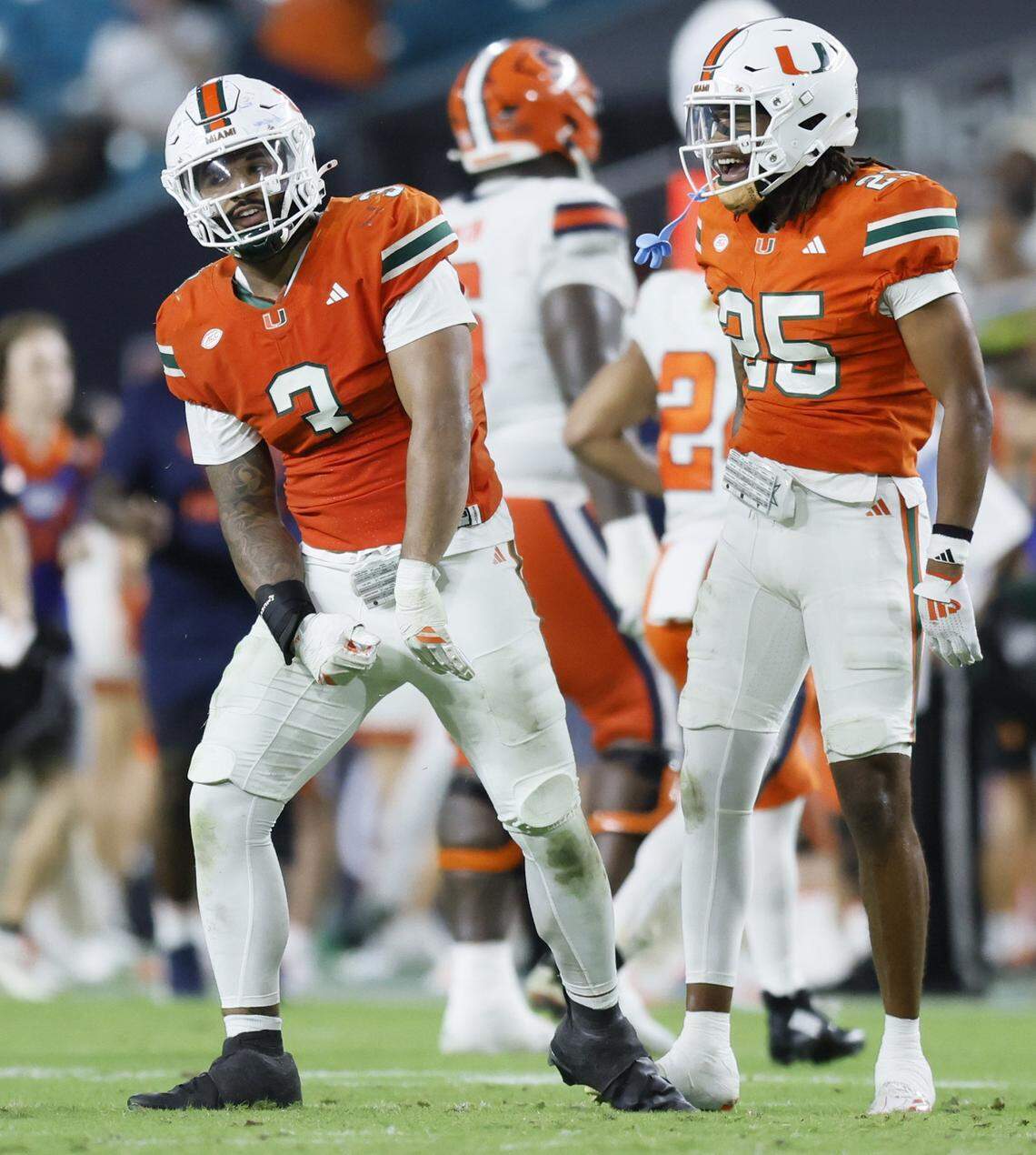 Miami Hurricanes defensive lineman Akheem Mesidor (3) and defensive back Jadais Richard (25) celebrate after sacking Syracuse Orange quarterback Rickie Collins (10) in the second half of an NCAA football game at Hard Rock Stadium in Miami Gardens, Florida on Saturday, November 8, 2025.