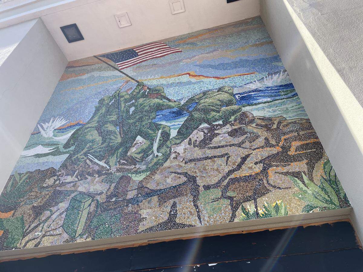 A mosaic mural by artist Enzo Gallo depicts U.S. Marines raising the American flag on Iwo Jima in Japan during World War II. The artwork is displayed on the former Wells Fargo building in Miami Beach at 1634 Alton Rd.