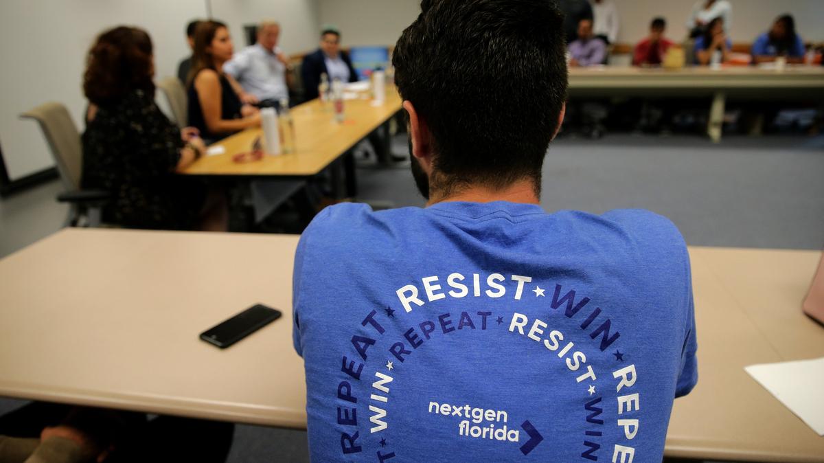 An activist attends a meeting Tuesday at Miami Dade College where billionaire Tom Steyer, founder of NextGen America, and others launched a voting drive in Florida and talked about the importance of young people voting in the 2018 elections.