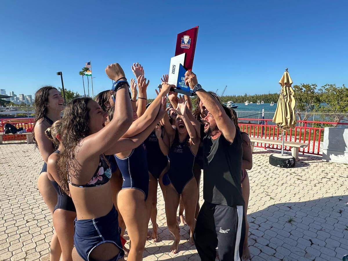 The MAST Academy girls’ water polo team celebrates after winning their third consecutive GMAC championship at its home pool on Tuesday.