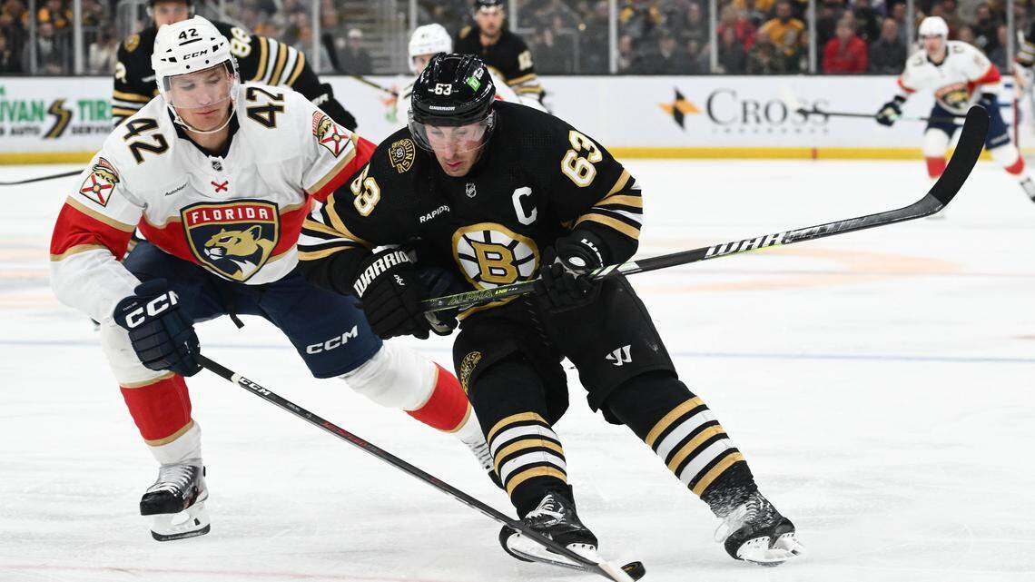 Oct 30, 2023; Boston, Massachusetts, USA; Florida Panthers defenseman Gustav Forsling (42) defends Boston Bruins left wing Brad Marchand (63) during the first period at the TD Garden.