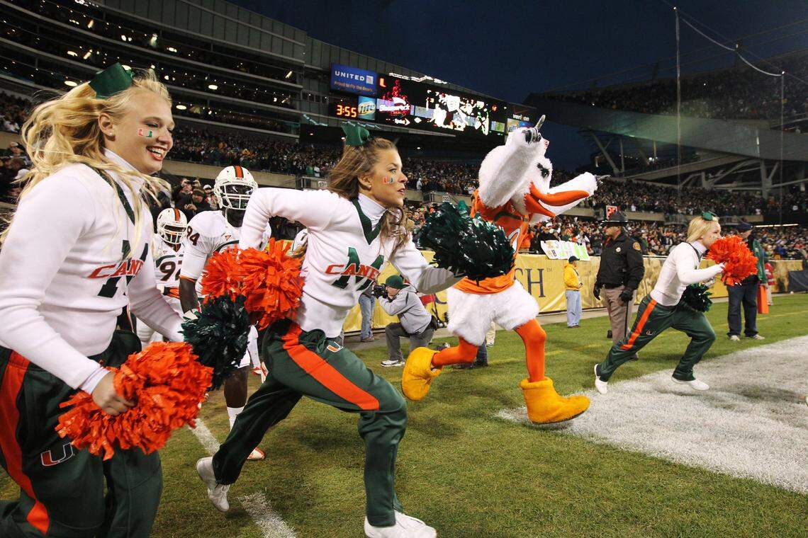 Miami cheerleaders run out onto the field during the pre-game of the University of Miami game against Notre Dame at Soldier Field in Chicago on Oct. 6, 2012.