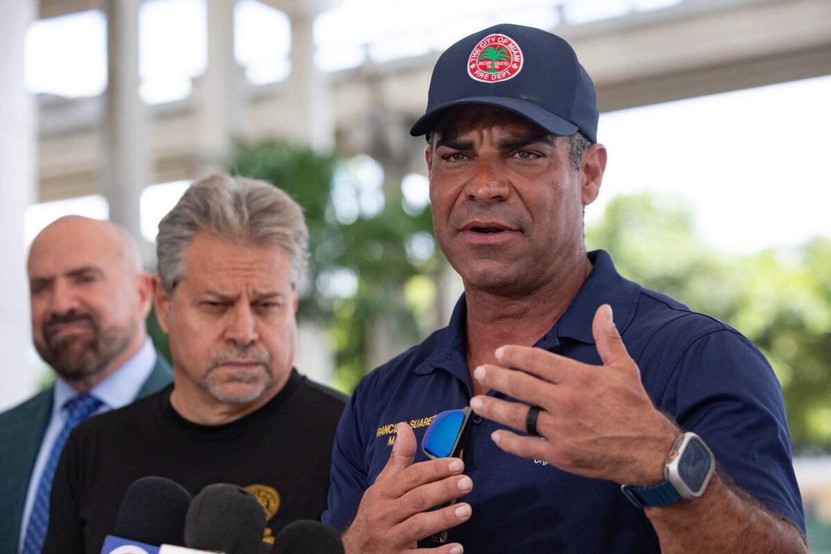 Mayor Francis Suarez (far right) gives a press release alongside Commissioner Damian Pardo (far left) and Commissioner Miguel Angel Gabela (middle) outside the Jose Marti Gym on 434 SW and 3rd Ave. before the residents of the Temple Court Apartments arrive on Monday, June 10, 2024 in Miami, Fla. The city officials said their main priority was to make sure the victims are provided with the help they need.