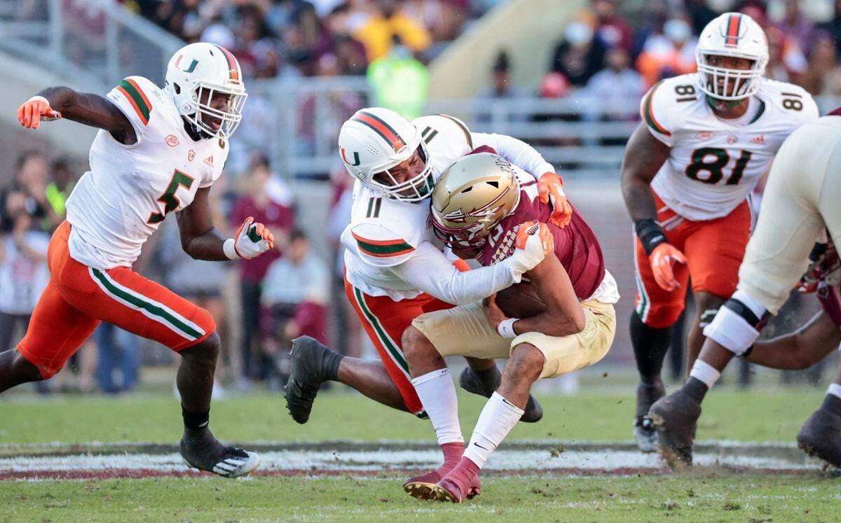 Miami Hurricanes linebacker Corey Flagg Jr. (11) sacks Florida State Seminoles quarterback Jordan Travis (13) in the first half at Doak Campbell Stadium in Tallahassee on Saturday, November 13, 2021