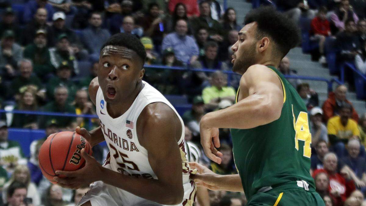 Florida State’s Mfiondu Kabengele (25) looks for room to drive against Vermont’s Isaiah Moll (14) during the first half of Thursday's first-round victory in the NCAA Tournament.