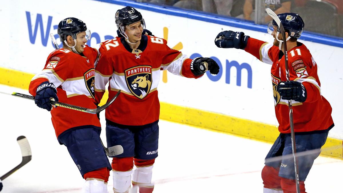 Florida Panthers center Denis Malgin (62) celebrates with teammates Jonathan Huberdeau (11) and Evgenii Dadonov (63) after scoring during the second period of an NHL regular season hockey game against the Pittsburgh Penguins at the BB&T Center on Tuesday, October 22, 2019 in Sunrise.
