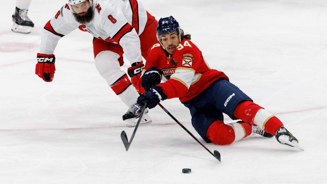 Florida Panthers left wing Ryan Lomberg (94) battle for the puck against Carolina Hurricanes defenseman Brent Burns (8) during the first period of an NHL game at FLA Live Arena on Wednesday, November 9, 2022 in Sunrise, Fl.