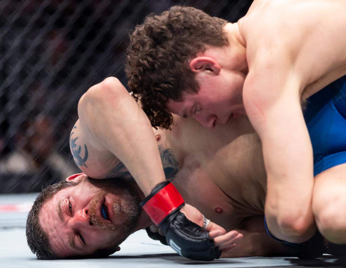 Chase Hooper of the United States fights against Jim Miller of the United States in their lightweight bout during UFC 314 at the Kaseya Center on Saturday, April 12, 2025, in downtown Miami, Fla.