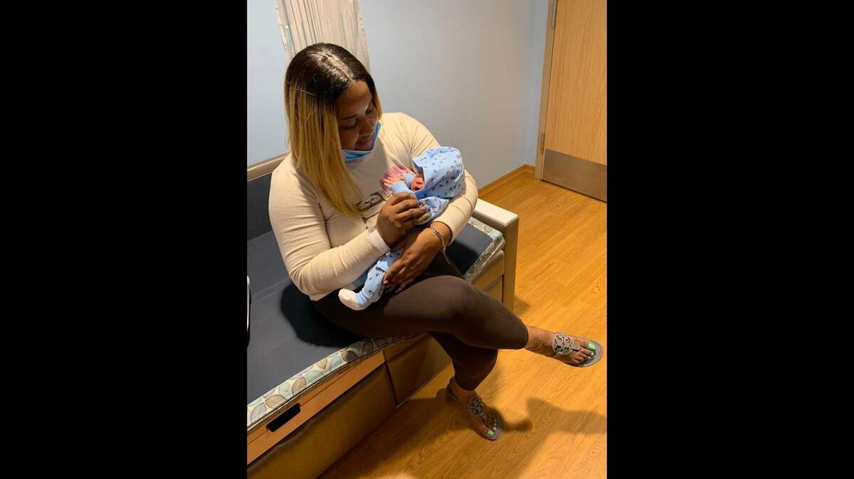 Tashika Robinson, 45, holds her granddaughter, D-Zani Yvette Burden, on Jan. 1, 2021. D-Zani was the first baby born in 2021 at Jackson Memorial Hospital.