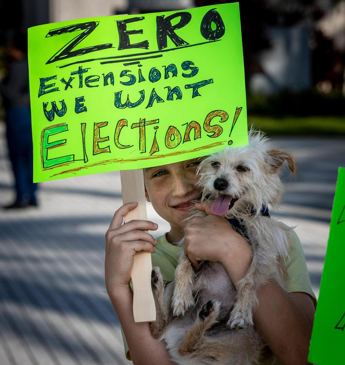 Ten year-old Jude Berry and his dog, Chomsky, were among a group of North Miami residents who rallied in front of North Miami City Hall to demand the city’s election be held this spring. A lawsuit was filed to force North Miami to hold its May 2023 elections. The city council in December voted to change the election cycle, thus extending council members’ terms.