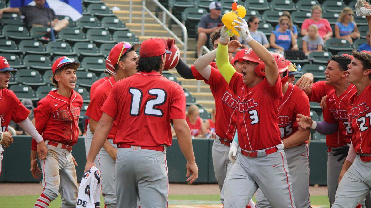 Doral Academy’s Daniel Restrepo celebrates with his teammates after hitting a 3-run home run in the fifth inning of the Firebirds’ Class 6A state championship game on Saturday at Hammond Stadium in Fort Myers.