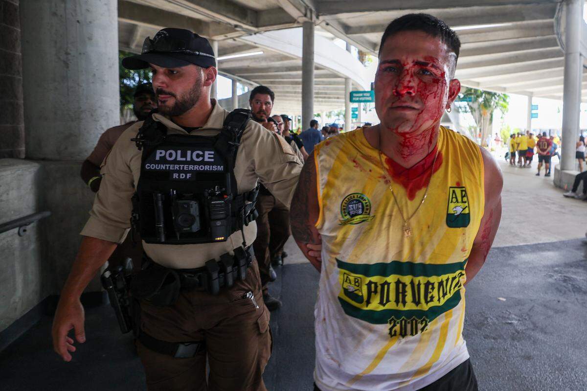 Jul 14, 2024; Miami, FL, USA; a fan is detained by police before the Copa America Final match between Argentina and Colombia at Hard Rock Stadium. Mandatory Credit: Nathan Ray Seebeck-USA TODAY Sports