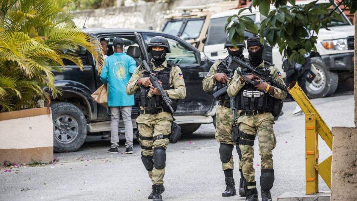 Police and forensics teams are seen at the entrance to the residence of late Haitian President Jovenel Moise in Port-au-Prince, July 15, 2021, in the wake of his assassination on July 7, 2021. - The assassination of Jovenel Moise by armed mercenaries was planned in the neighboring Dominican Republic, say Haitian police, who announced the detention of the slain president's chief bodyguard and three other members of his security detail. The United States has sent members of the Federal Bureau of Investigation (FBI), State Department, Justice Department, National Security Council and Department of Homeland Security to Haiti. (Photo by Valerie Baeriswyl / AFP) (Photo by VALERIE BAERISWYL/AFP via Getty Images)