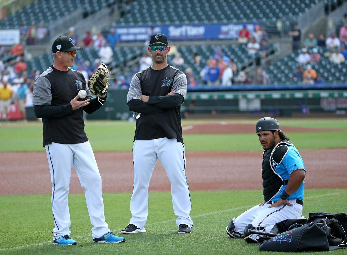 From left to right, Miami Marlins catching coach Brian Schneider (23) Marlins Special advisor to baseball operations Jorge Posada and catcher Jorge Alfaro (38) talk before the start of a Major League Baseball spring training game against the New York Mets at the Roger Dean Chevrolet Stadium on Tuesday, March 5, 2019 in Jupiter, FL.