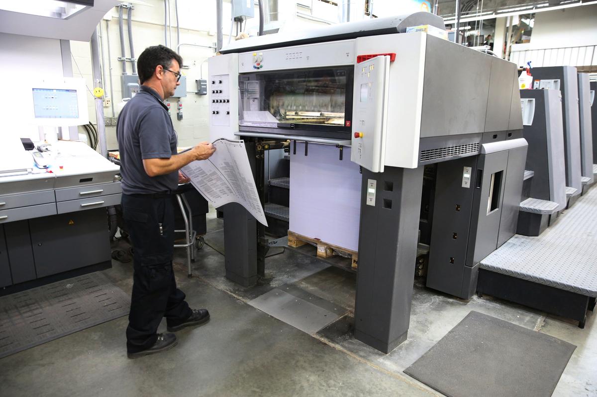 Enrique Dieguez pulls a freshly printed ballot off of the press for a  quality control check, Monday, Sept. 24, 2018, at Miami-Dade’s Internal Services Department print shop.