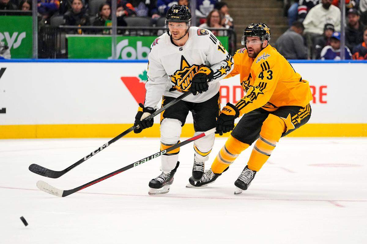 Feb 3, 2024; Toronto, Ontario, CAN; Team McDavid center Sam Reinhart (13) of the Florida Panthers and Team MacKinnon right wing Tom Wilson (43) of the Washington Capitals go for the puck in the 2024 NHL All-Star Game at Scotiabank Arena. Mandatory Credit: John E. Sokolowski-USA TODAY Sports