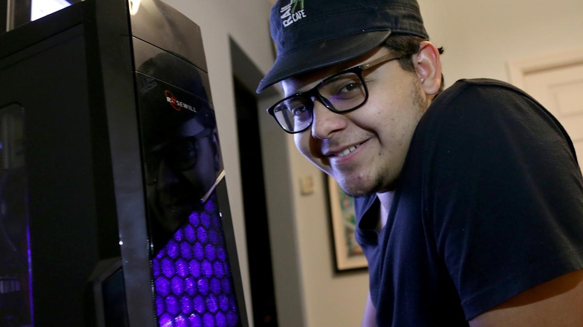 Carlos Zelaya posed next to his computer, he was a homeless teenage computer whiz who built a PC, he wish to replace his homemade PC with a laptop that has Word so he can do college homework and bring it to the library at Miami Dade College For Wishbook, on Friday December 22, 2018.