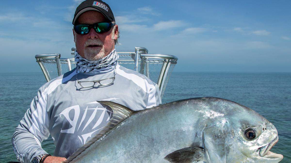 Angler Bob Brady holds a permit caught and released in Biscayne Bay, part of a protected zone that stretches to the Keys and Southwest Florida where it is illegal to commercially harvest the fish.