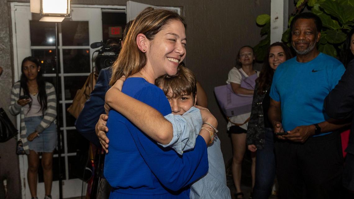 Sabina Covo, the winner of the District 2 special election in the city of Miami gets a hug from her 10-year-old son Paolo during a celebration at The Taurus in Coconut Grove, 3540 Main Highway, Miami, on Monday, Feb. 27, 2023.