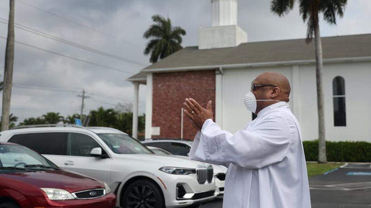 The Sunshine Cathedral in Fort Lauderdale holds a drive-in Easter service in its parking lot. Each car received a Ziploc bag with a prayer card, palm leaf and pre-packaged communion.