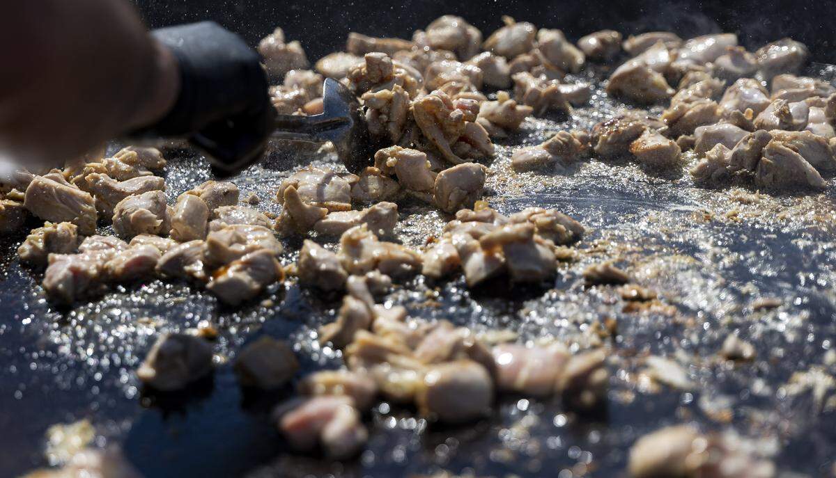 Eldre Siles, a sous chef at Bulla Gastrobar, prepares chicken for a paella as guest attend the Goya Foods' Grand Tasting Village during the Food Network South Beach Wine & Food Festival on Saturday, Feb. 21, 2026, in Miami Beach, Fla.