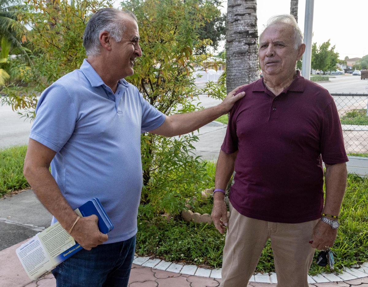 Hialeah mayoral candidate Esteban ‘Steve’ Bovo, left, greets a supporter while out in the neighborhood campaigning on Sept. 23, 2021.