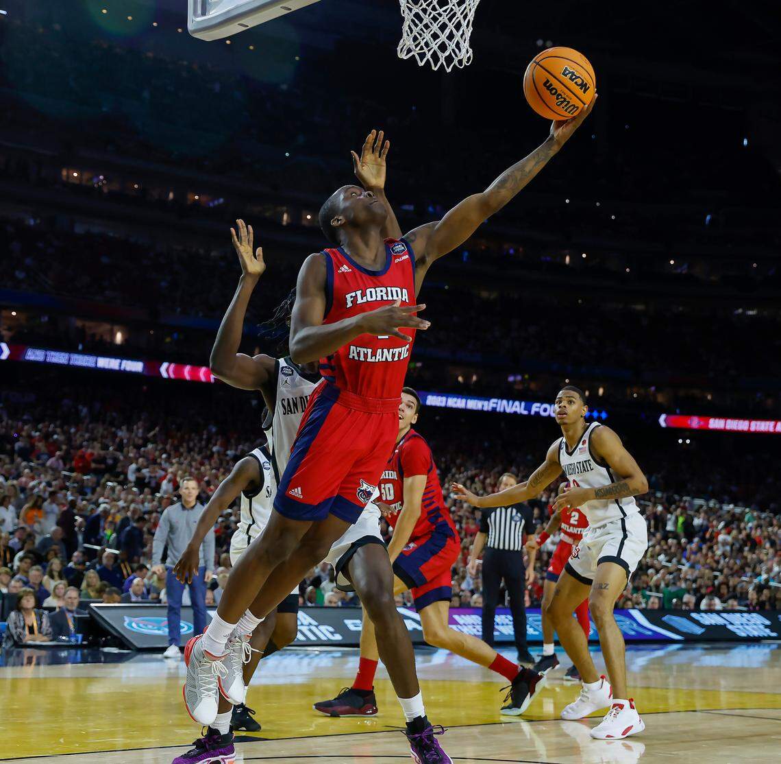 Florida Atlantic Owls guard Johnell Davis (1) goes to the basket San Diego State Aztecs forward Nathan Mensah (31) during the second half of the Men’s Basketball Championship National Semifinal at NRG Stadium in Houston, Texas on Saturday, April 1, 2023.