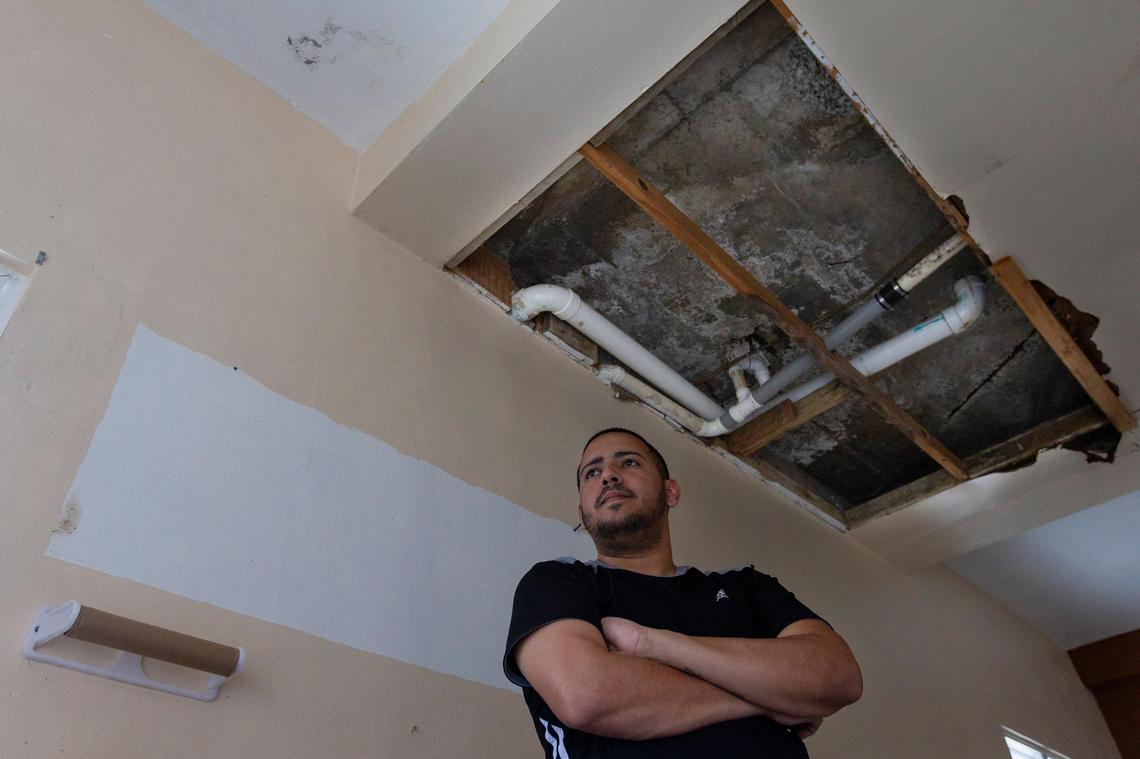 Waldemar Rosado, 28, stands under his partially collapsed roof of his kitchen in the La Juncia community in Comero, Puerto Rico on August, 25, 2018. Rosado and his family are unable to live in the home which was severely damaged during Hurricane Maria last year.