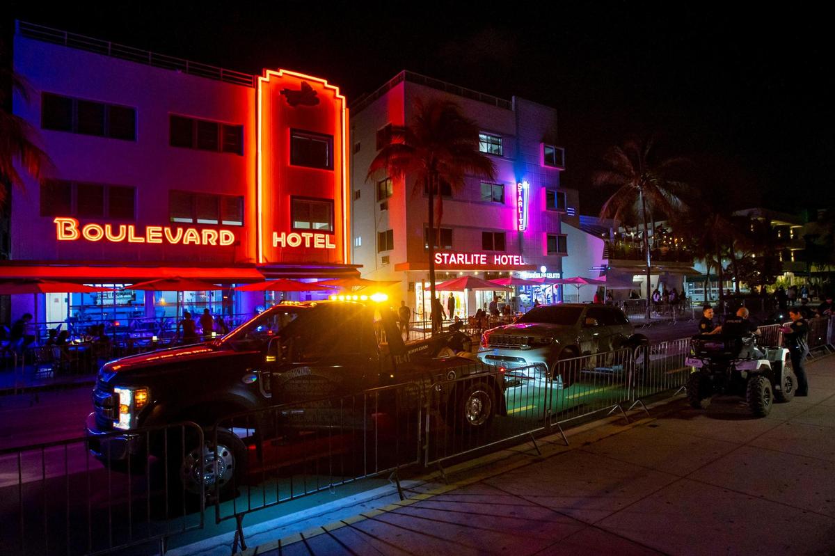 A car gets towed in front of the Boulevard Hotel as people walk Ocean Drive on Friday, May 27, 2022.