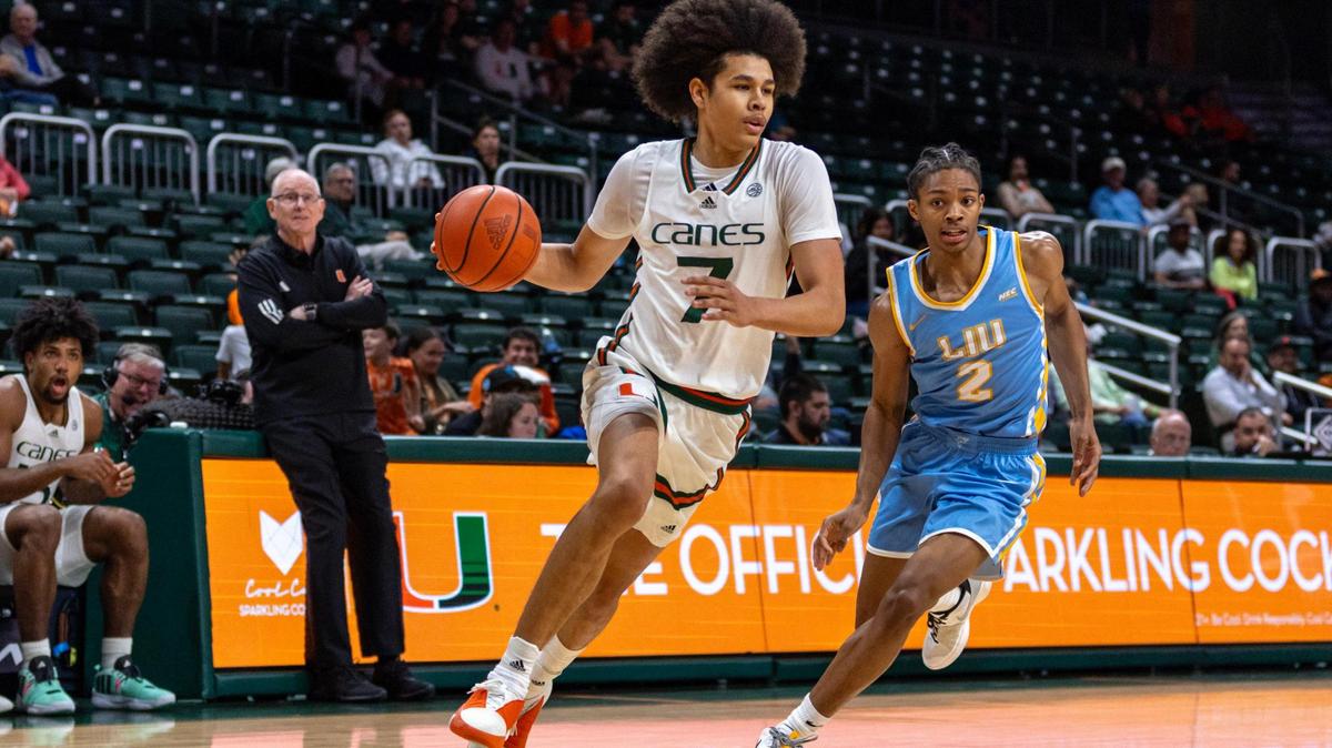 Miami Hurricanes guard Kyshawn George (7) dribbles past Long Island University guard Eric Acker (2) during the second half of an NCAA basketball game at the Watsco Center in Coral Gables, Florida, on Wednesday, December 6, 2023.