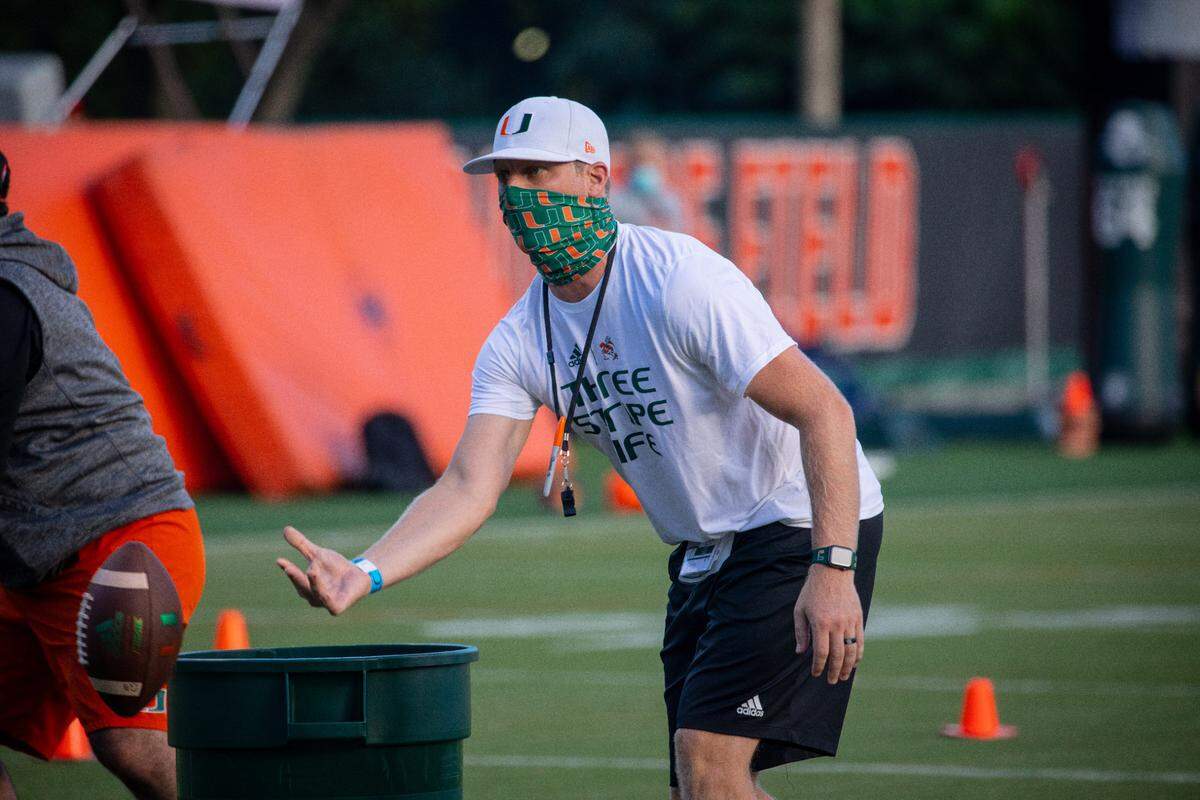 Rhett Lashlee leads a drill on the first day of the Miami Hurricanes’ 2020 training camp. The first-year offensive coordinator dons a face covering because of COVID-19 concerns.