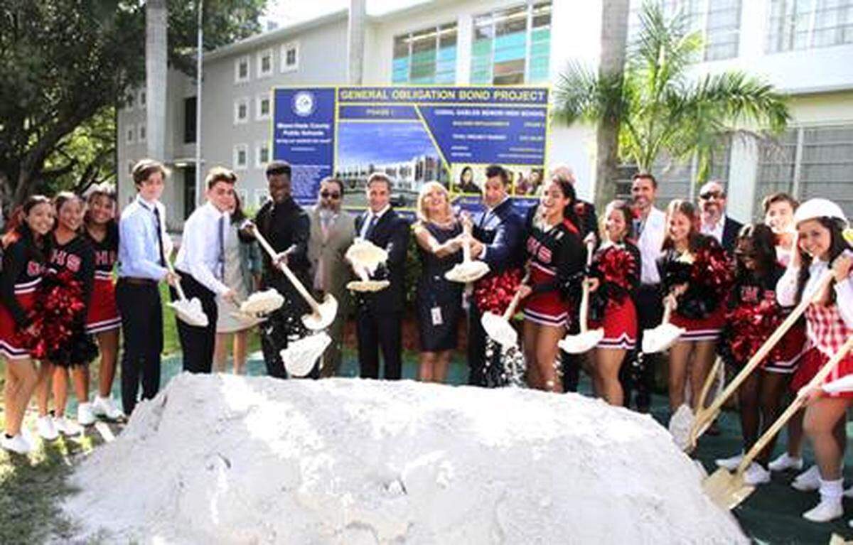 Miami-Dade County Public Schools Superintendent Alberto Carvalho (center) is joined by School Board member Mari Tere Rojas (right of center), Coral Gables Principal Adolfo Costa (left of center), and students to officially kick off renovations at Coral Gables Senior High School.