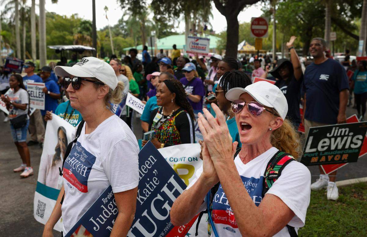 Cherrelyn Seegers, right, cheers in support of Democratic candidate Kamala Harris during the Souls to the Polls march to the African American Research Library and Cultural Center on Sunday, Aug. 18, 2024, in Fort Lauderdale, Fla.