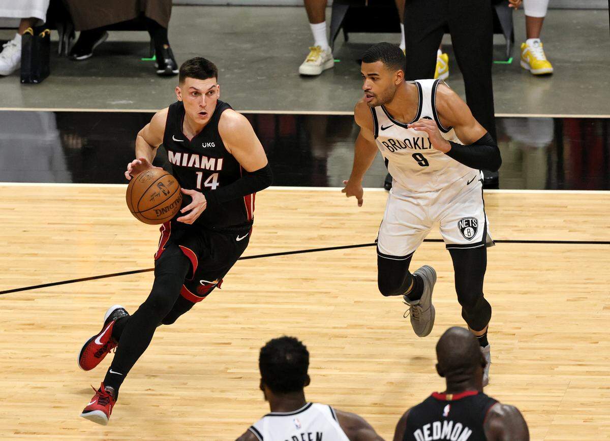 Miami Heat guard Tyler Herro (14) drives to the basket against Brooklyn Nets guard Timothe Luwawu-Cabarrot (9) in the third quarter of their NBA basketball game at AmericanAirlines Arena on April 18, 2021.